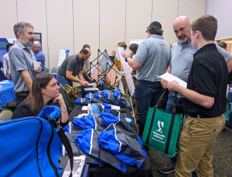 Photo of students speaking with employers at the Power the World Career Fair