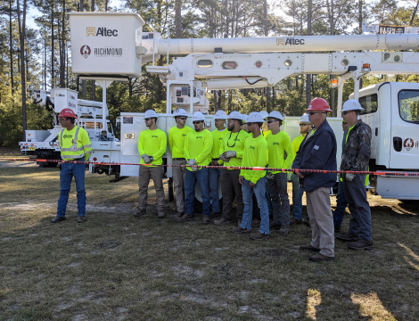 Electric Lineman Standing Before Truck