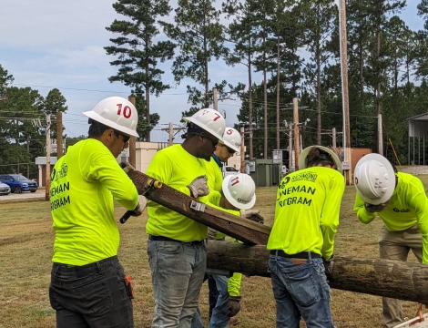 Electric Lineworker Students raising a powerline pole