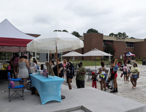 Families at RichmondCC, celebrating on the Patio as they stand in line to get cotton candy