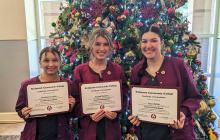 CNA graduates holding their certificates