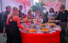 Photo of people in formal attire making plates of food at the Gala