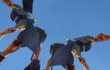 Graduation caps held up in the sky