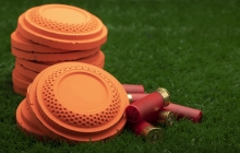 photo of clay pigeons and shotgun shells on grass