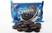 A photo of a case of oreos with oreo cookies in the foreground