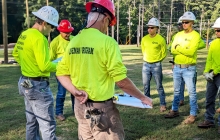 A photo of the previous class of lineman students working in the lineman yard