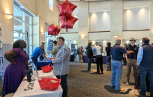 Multiple students speaking with employers at booths at the Power the World Career Fair of Fall 2025