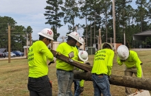 Electric Lineworker Students raising a powerline pole