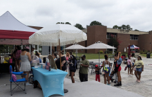 Families at RichmondCC, celebrating on the Patio as they stand in line to get cotton candy